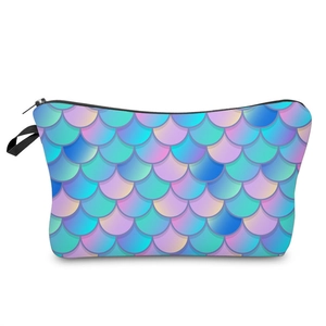 Close-up of mermaid scale pattern makeup bag with purple blue gradient and black handle