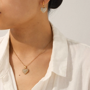Gold plated heart jewelry set featuring sparkling zircon necklace and earrings on model