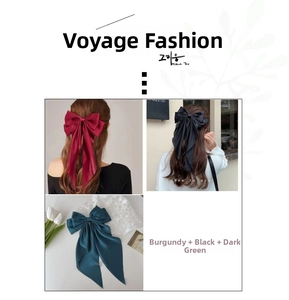 Detailed view of elegant satin bow hair clips in wine red, black and dark green colors