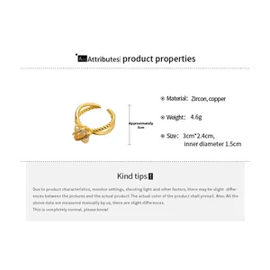 Detail view of gold crisscross ring with zircon inlay and exact weight and size specs