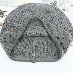 Chic grey openwork knit beanie for women with intricate crochet texture on white background