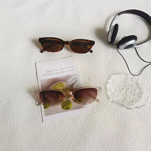 Flat lay of tortoiseshell and pink square sunglasses with UV protection on white background
