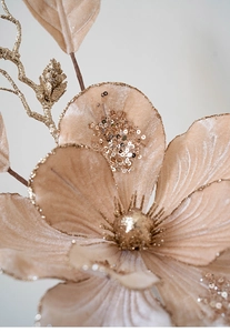 Macro detail of champagne velvet artificial flower with golden glitter and sequins