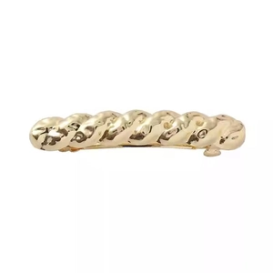 Elegant gold twisted braid metal hair clip with a sleek polished finish on white background