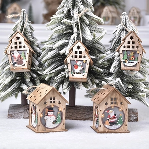 Wooden Christmas hanging ornaments featuring Santa and reindeer on snowy tree branches