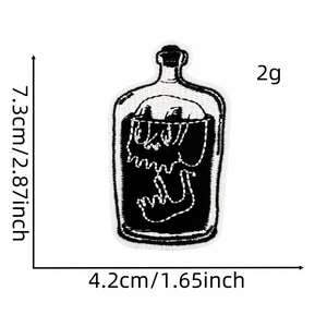Detail of skull in bottle embroidered patch with size dimensions 7.3cm x 4.2cm