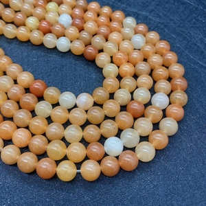 Macro shot of polished 8mm round natural aventurine stone beads for jewelry making