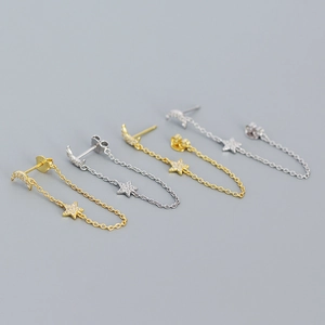 Macro detail of S925 sterling silver star and moon earrings with cubic zirconia inlay