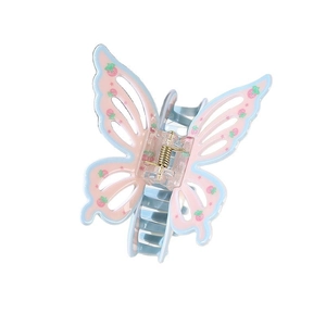 Detail shot of butterfly hair claw with strawberry prints and blue trim on pink base