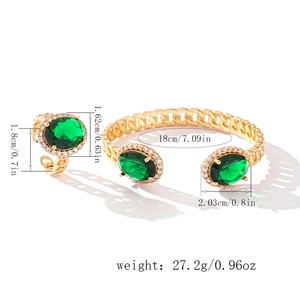 Detail view of gold bridal jewelry set with green oval zircon and size measurements