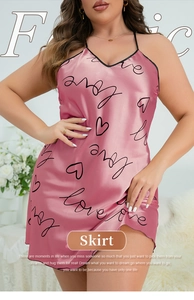Close-up of pink satin sleepwear with black love heart prints and delicate V-neckline