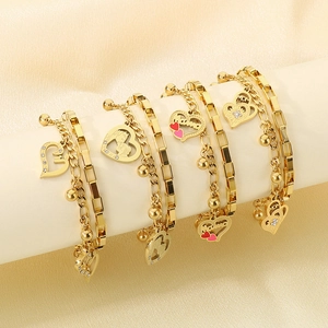 Detail view of gold layered heart bracelets with MAMA and MOM charms on display