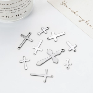 Flat lay of various silver stainless steel cross pendants for DIY jewelry and accessories