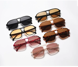 Flat lay of aviator sunglasses in various colors including tortoiseshell and black frames