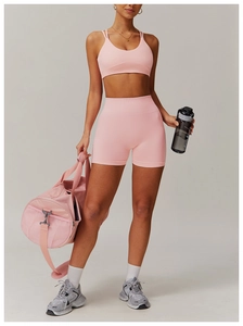 Detailed view of pink seamless yoga set with racerback bra and high-waisted shorts