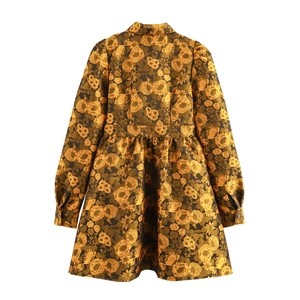 Retro black A-line dress with gold floral jacquard and pleated skirt, back view
