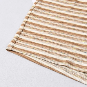 Detail of tan and beige striped knit fabric with ribbed texture and rolled hem stitching