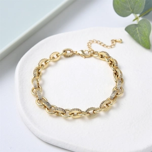 Macro shot of gold chain bracelet with zircon micro-pave details and lobster clasp