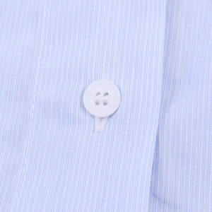 Macro shot of light blue striped woven fabric with a white four-hole button detail