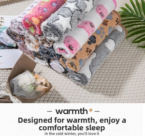 Stack of warm flannel pet blankets with star and paw patterns in pink, grey and coffee