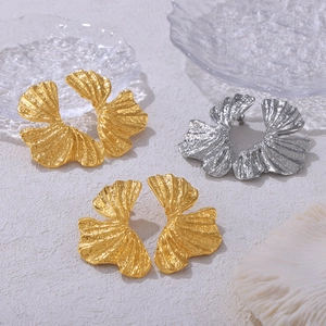 Textured ginkgo leaf stud earrings in gold and silver finish with hammered metal surface
