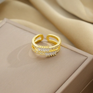 Macro shot of double-layer gold plated ring with rectangle zircon on silk fabric