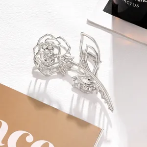 Detailed view of silver metal rose hair claw clip with sparkling rhinestone accents