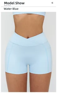 Close-up of sky blue yoga shorts featuring a V-shaped crossover high waist and side pockets