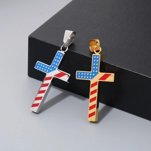 Close-up of silver and gold cross necklaces featuring an American flag pattern design