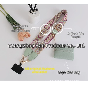 Detail of bohemian geometric woven shoulder strap with mint green pouch and gold buckles