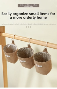 Hanging cotton linen storage bag organizer for dorm room, wall mounted pocket for small items.