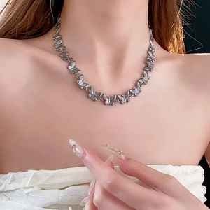 Elegant titanium steel butterfly necklace in silver finish for women on model