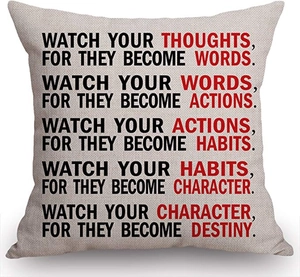 Detailed view of square linen pillow featuring printed inspirational quotes and text