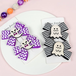 Detail of Halloween ghost hair clips with purple wavy and black-white stripe bows