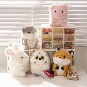 Close-up of five fluffy animal plush keychains including a pig, hamster, and bunny charms