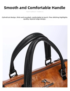 Close-up of textured leather brown handbag featuring black handles and metal D-ring hardware