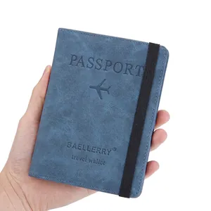 Blue matte leather RFID passport holder with elastic strap and engraved travel logo