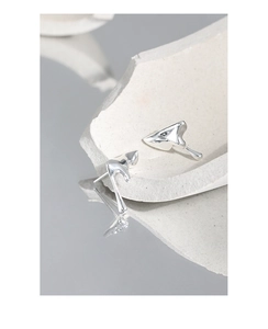 Macro shot of irregular molten silver stud earrings with high-polish metallic finish