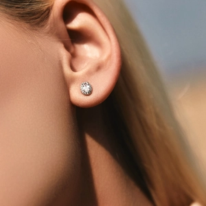 Elegant s925 silver oval halo stud earrings with brilliant diamonds worn by a model