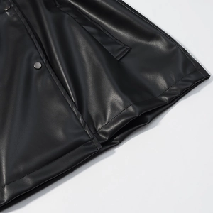 Detailed close-up of black PU leather coat featuring drawstring waist and metal buttons