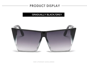 Detail shot of oversized geometric sunglasses with black grey gradient lenses