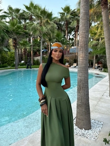 Detail of elegant olive green one-shoulder pleated maxi dress with summer resort vibes