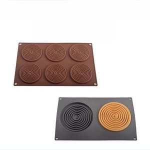 Macro detail of food-grade silicone molds with spiral vortex pattern for DIY baking