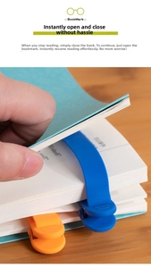 Detail showing hand using blue silicone auto-track bookmark on book pages