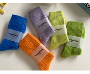 Detailed view of colorful ribbed wool socks in blue orange purple yellow and green