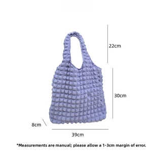 Macro shot of lavender bubble puff tote bag showing soft textured fabric and dimensions