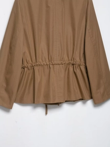 Detail view of the khaki field jacket featuring back waist drawstring and pleated hem