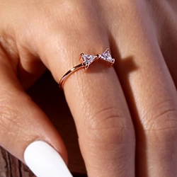 Close-up of rose gold open ring with triangle-shaped cubic zirconia on model finger