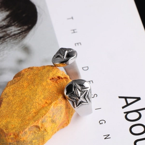 Close-up of vintage silver starfish ring detail resting on orange stone prop