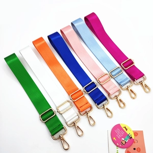 Detail of adjustable nylon bag straps with gold metal hooks in multiple vibrant colors